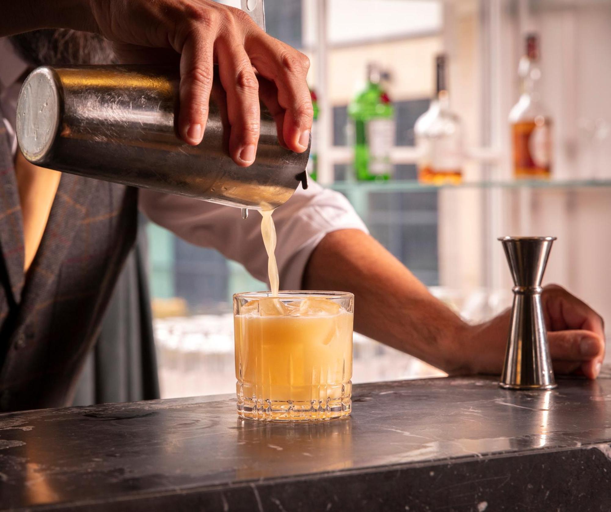Schloss Roxburghe, Part Of Destination By Hyatt Kültér fotó A bartender straining a cocktail